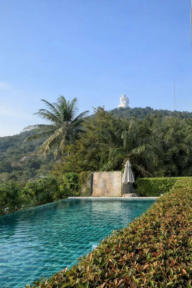 The infinity pool at Santosa, with the green hillside and the Big Buddha in the distance