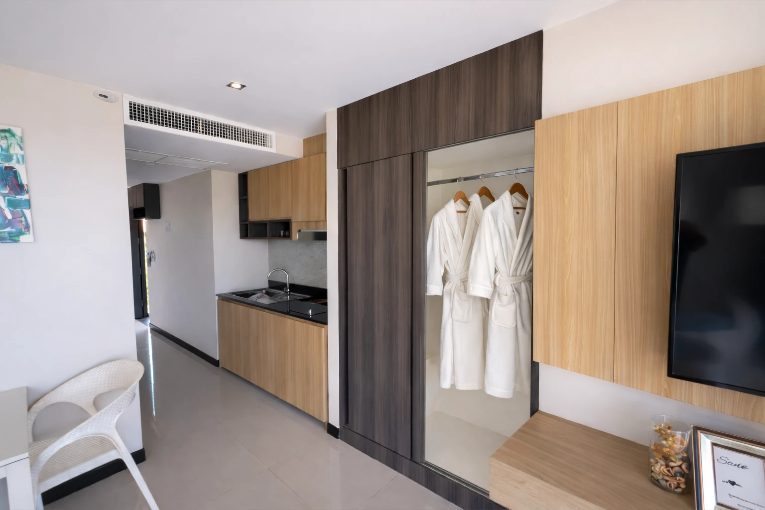 The kitchenette and the wardrobe with bathrobes