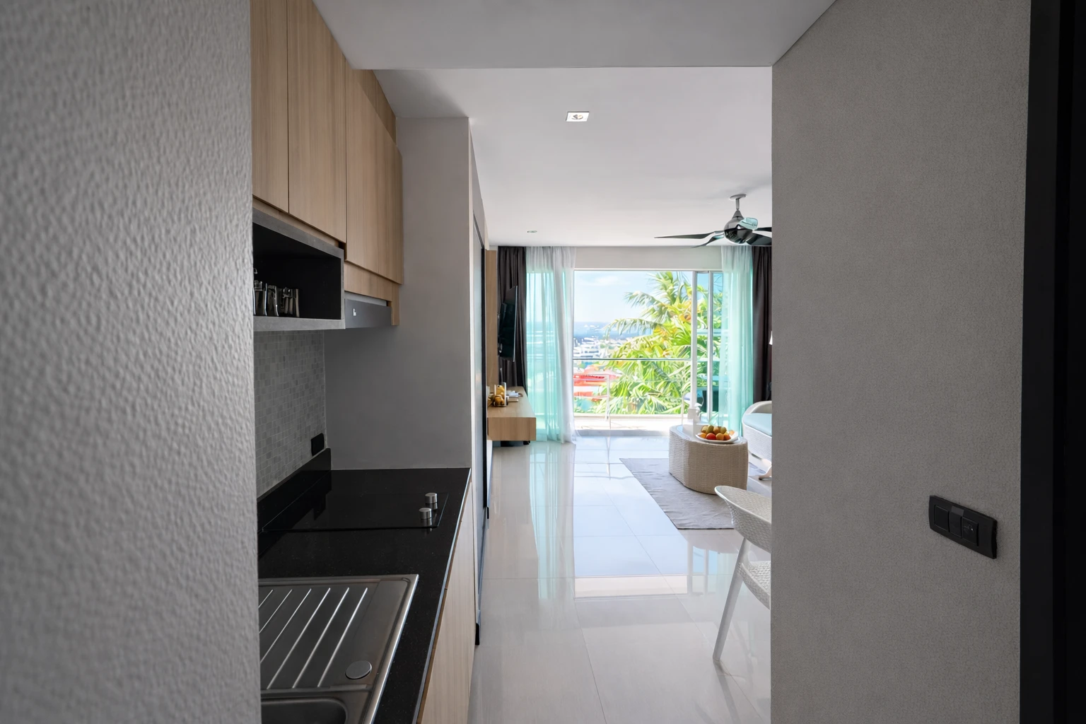 From the kitchenette through the lounge to the balcony and the sea