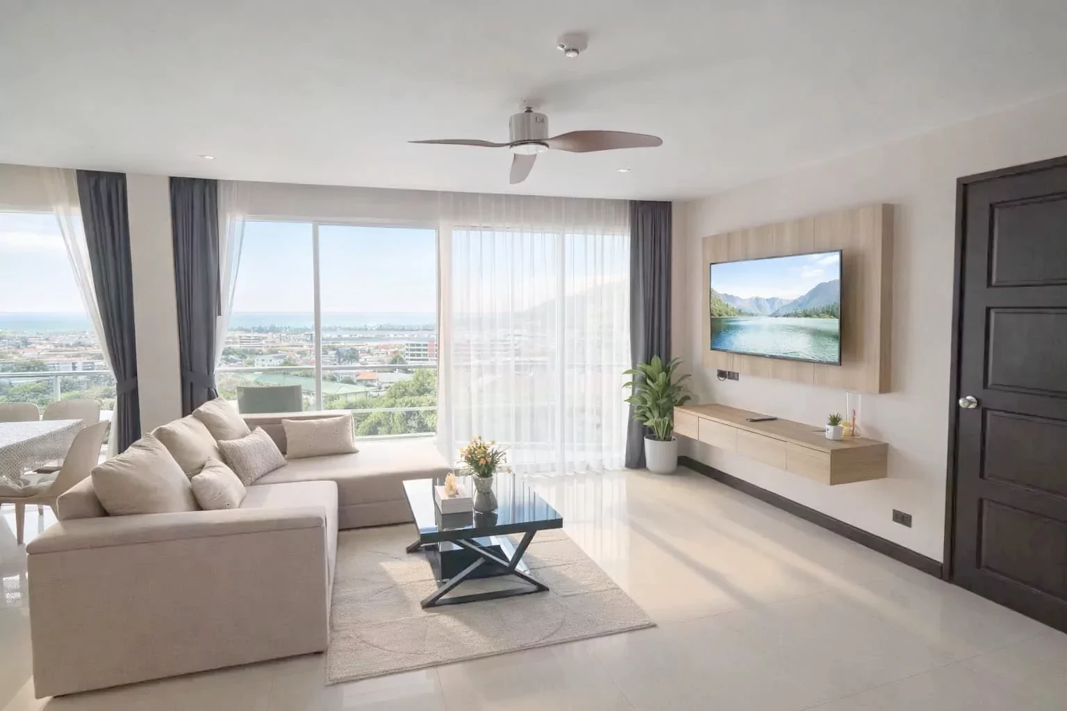 The lounge area, with the balcony doors open onto the sea