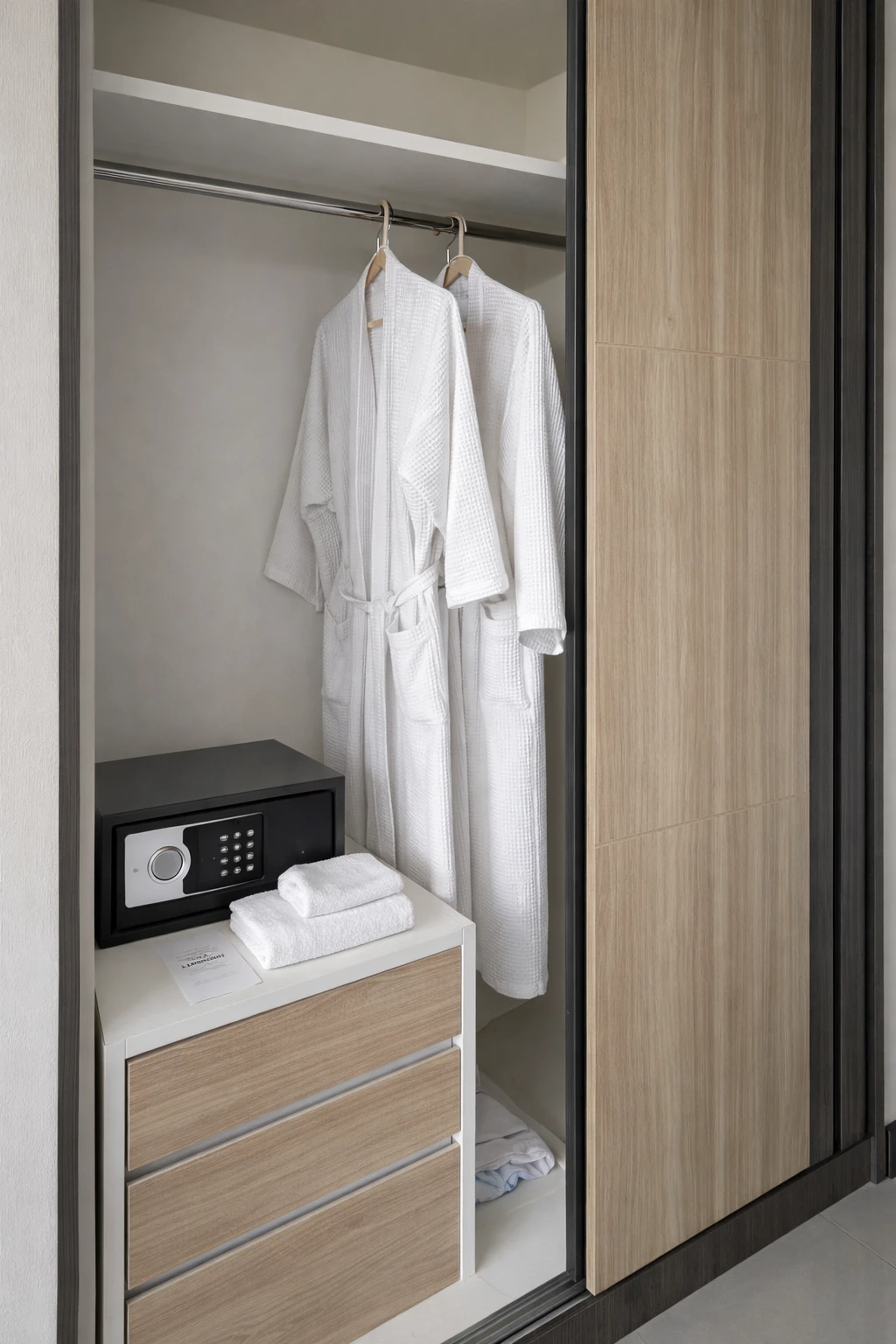The wardrobe, with bathrobes, towels and an in-room safe