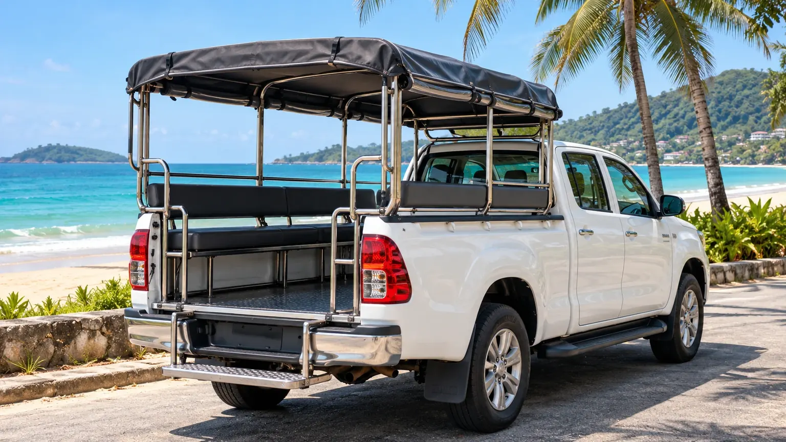 The hotel shuttle, an open-back pickup with bench seats, parked by the beach